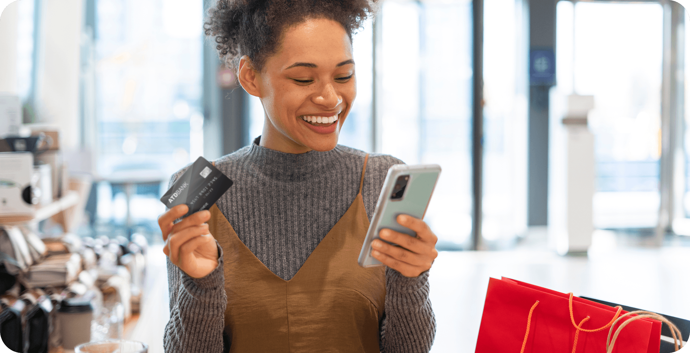 Woman with card and phone shopping